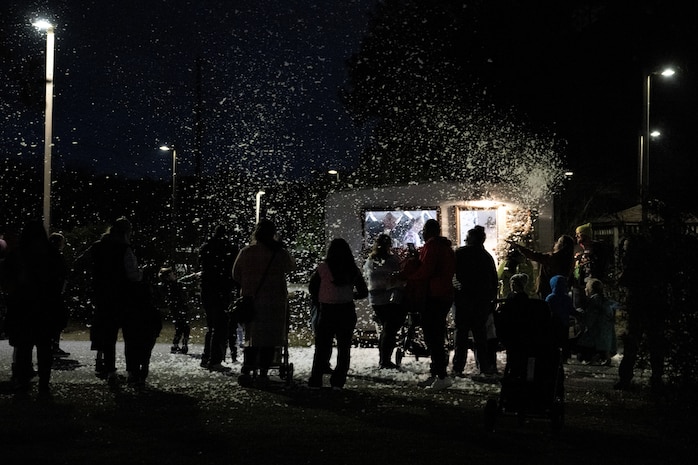 A photo of several people looking at snow.