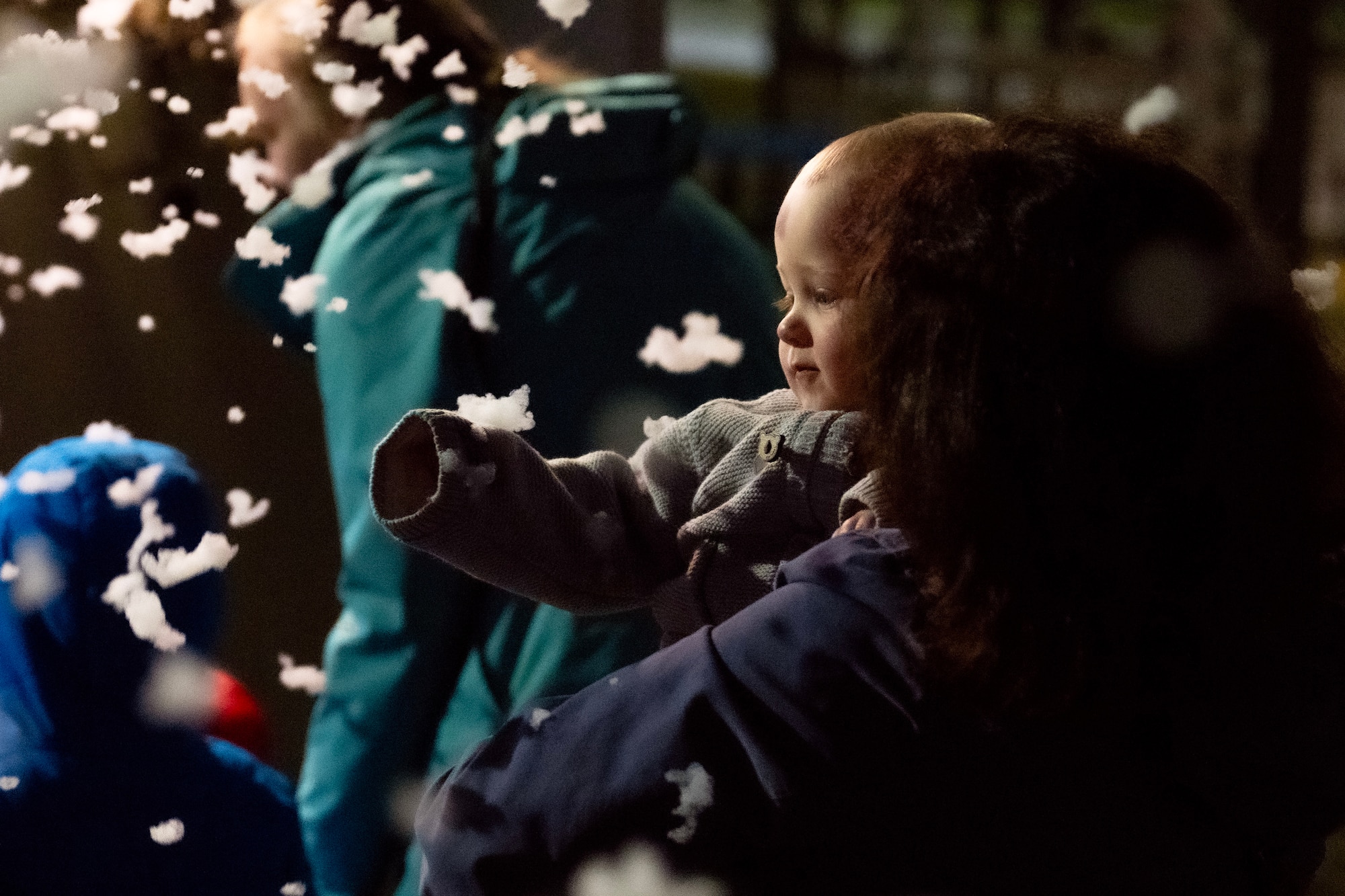A photo of a child looking at snow.