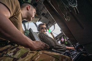 Two people talking in the cockpit of an aircraft