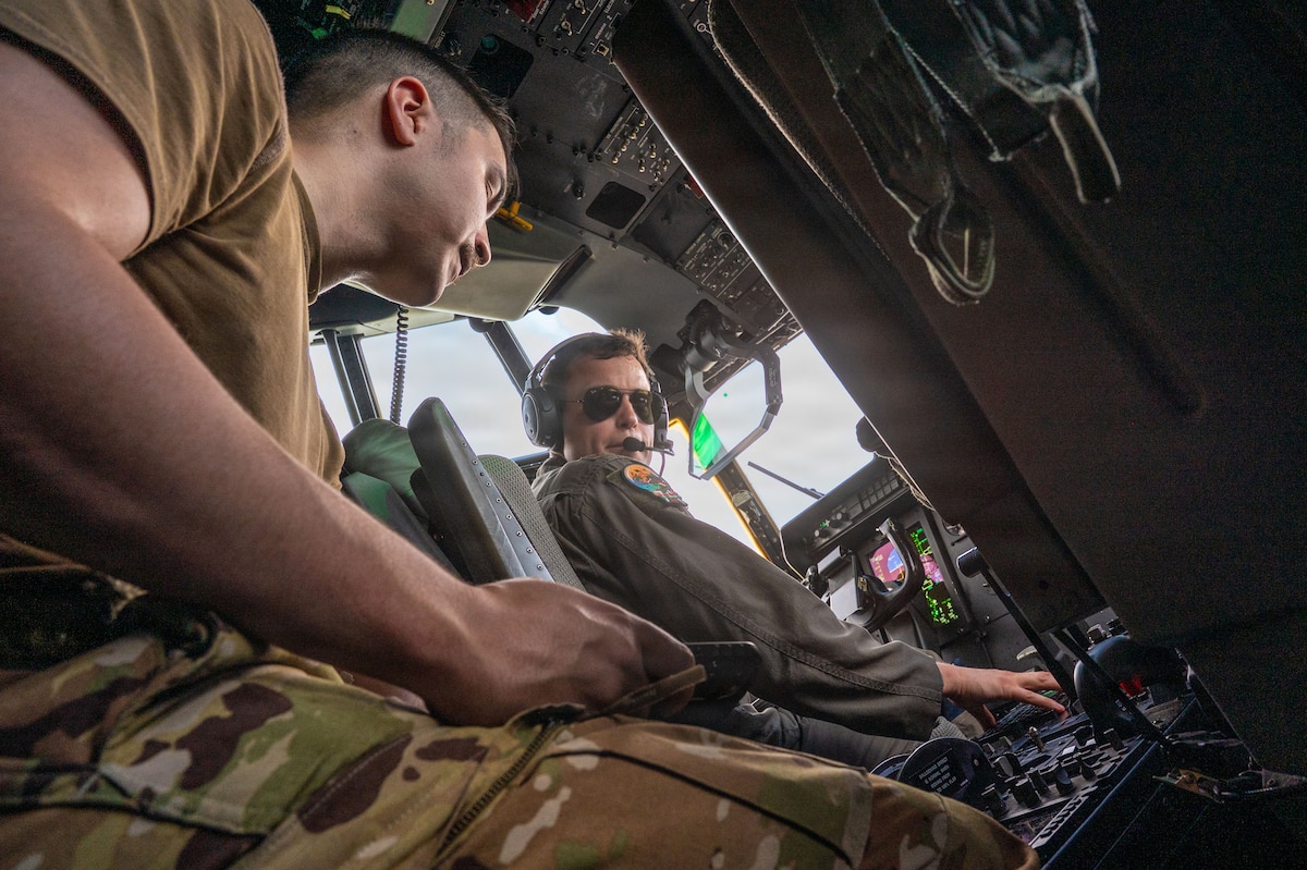 Two people talking in the cockpit of an aircraft