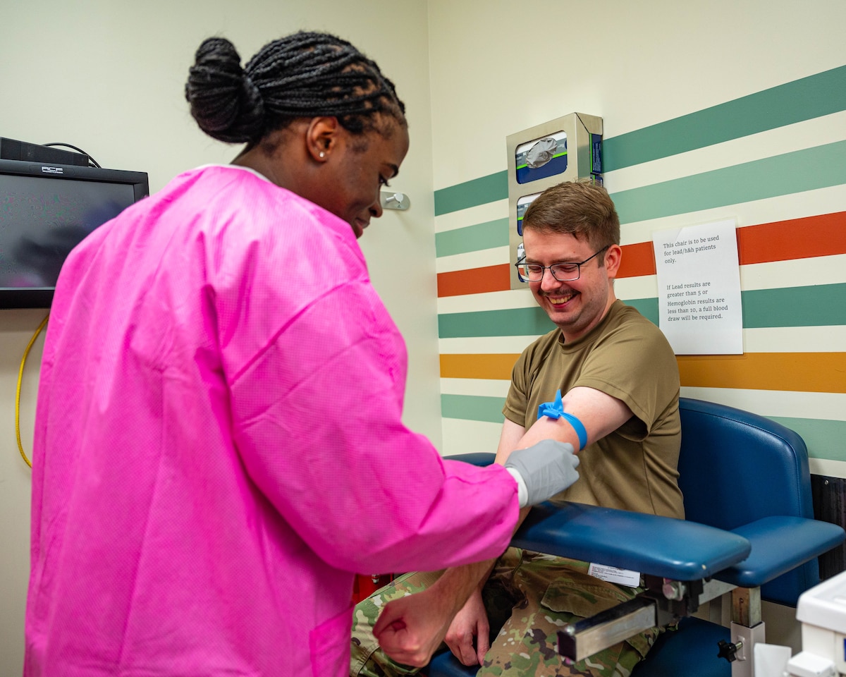 U.S. Air Force Senior Airman Evalyn McBryde (left), 56th Medical Support Squadron medical lab technician, prepares a patient for a blood draw, Nov. 20, 2025, at Luke Air Force Base, Arizona.