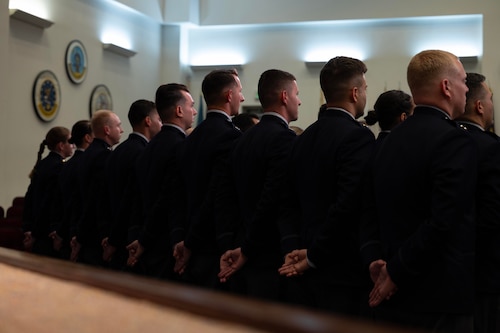 U.S. Space Force officer trainees stand in formation wearing their new service dress in preparation for Officer Training School graduation at Maxwell Air Force Base, Alabama, Dec. 4, 2025. One hundred officer trainees per year commission as Space Force Second Lieutenants through OTS, and 17 Guardians graduated in this week’s iteration of new officers. (U.S. Air Force photo by Tech. Sgt. Savannah L. Waters)