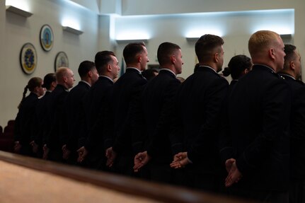 U.S. Space Force officer trainees stand in formation wearing their new service dress in preparation for Officer Training School graduation at Maxwell Air Force Base, Alabama, Dec. 4, 2025. One hundred officer trainees per year commission as Space Force Second Lieutenants through OTS, and 17 Guardians graduated in this week’s iteration of new officers. (U.S. Air Force photo by Tech. Sgt. Savannah L. Waters)