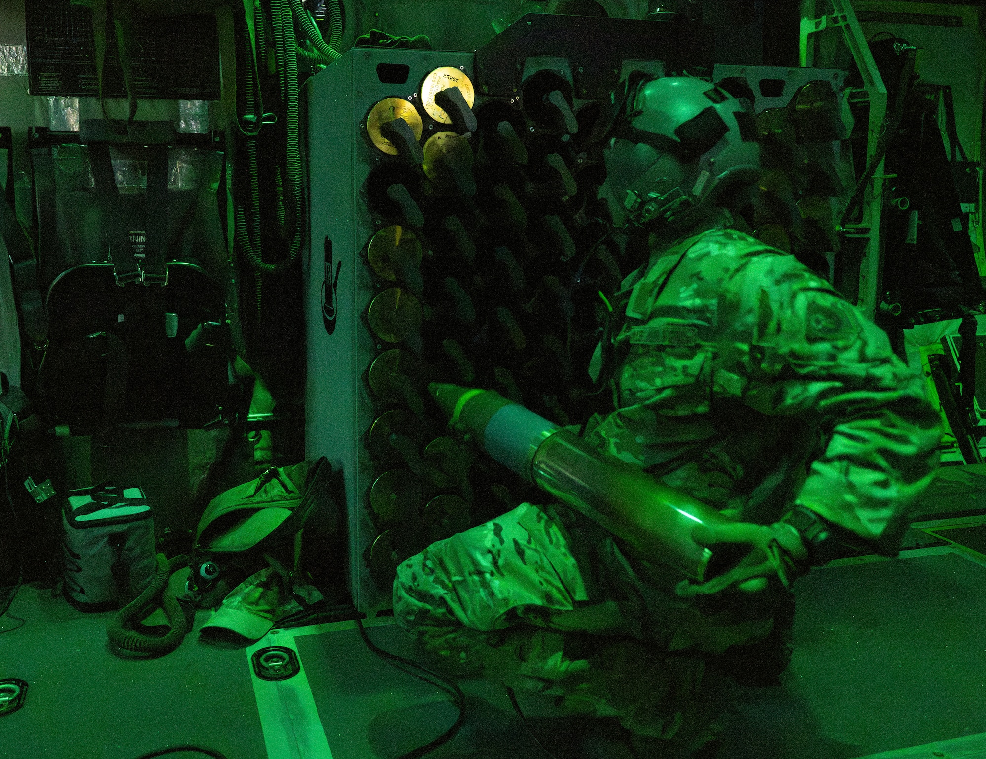 A U.S. Air Force special mission's aviator assigned to the 1st Special Operations Wing racks 105-mm rounds aboard an AC-130J Ghostrider gunship during a routine training mission at Hurlburt Field, Florida, Nov. 12, 2025.