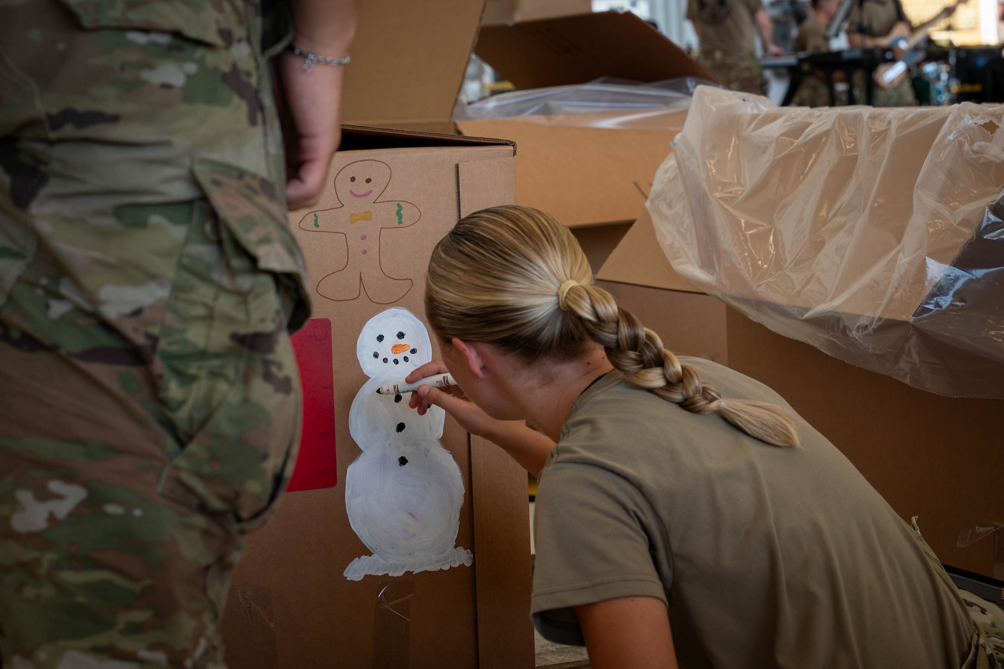 Service members decorate bundles.