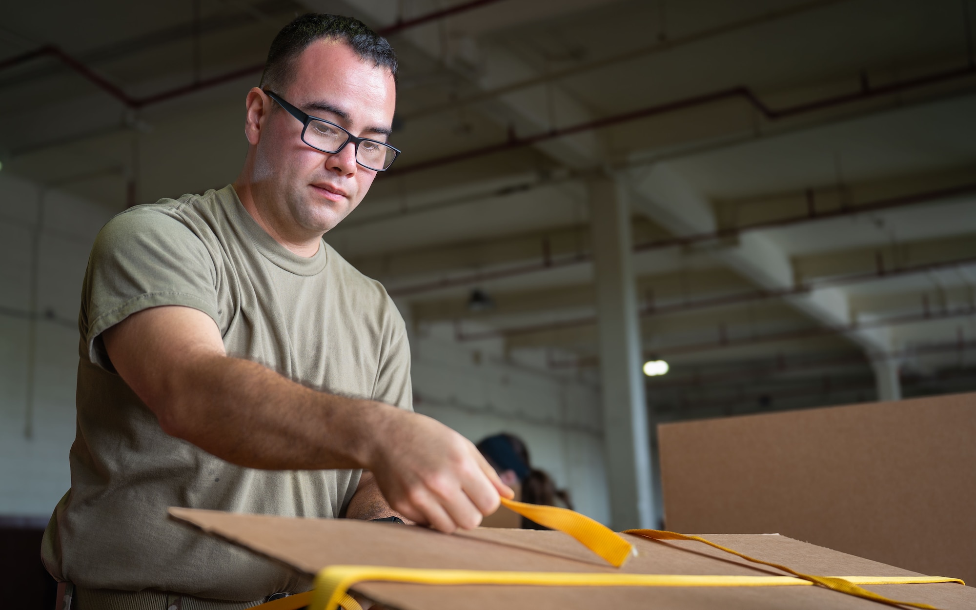 Airman tightens straps.