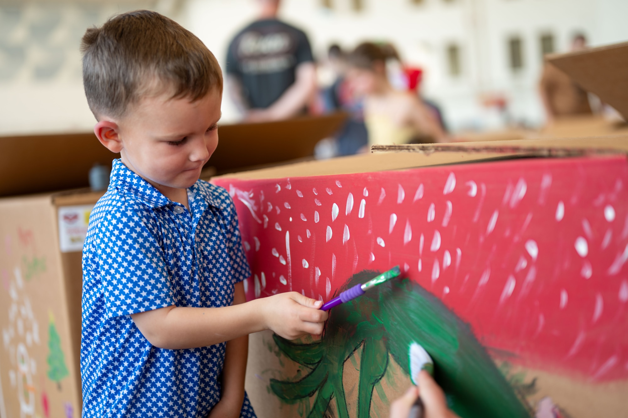 A child paints box.