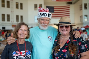 Brother Bruce and volunteers smile.