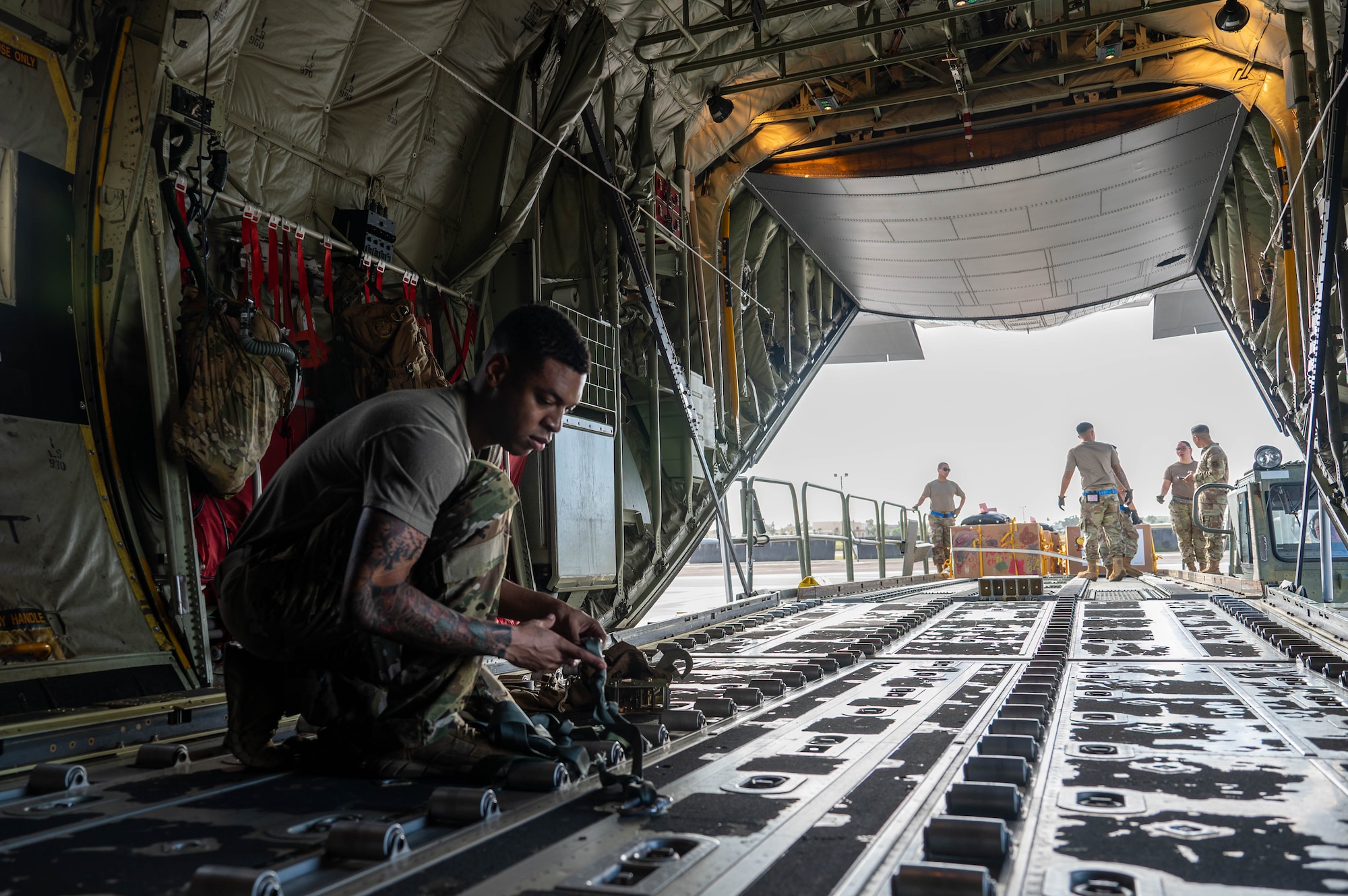 A military member works on a C-130J aircraft.