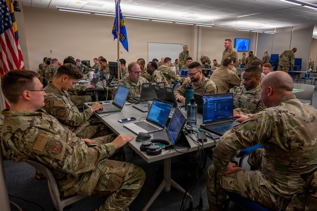 Service members from the 175th Cyberspace Operations Group at Martin State Airport and Fort Meade and the Maryland Army National Guard Cyber Protection Team 169 work in teams to compete in the 175th Cyberspace Operations Group Capture the Flag event, December 5, 2025, Warfield Air National Guard Base at Martin State Air National Guard Base, Maryland.