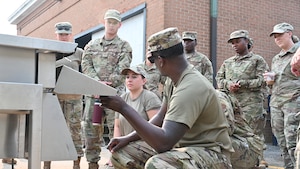 A New York Air National Guard 105th Airlift Wing Services member trains Airmen on the Disaster Relief Mobile Kitchen Trailer (DRMKT) during exercise Montauk Lightning II at the State University of New York, Stony Brook Southampton campus, in Southampton, N.Y., on August 5, 2025.