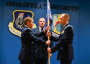 U.S. Air Force Lt. Col. James Liston, a 101st Rescue Squadron HH-60W Jolly Green II pilot, receives the 101st Rescue Squadron guidon from U.S. Air Force Col. Sean Garell, 106th Operations Group commander, during a Change of Command ceremony at the New York Air National Guard’s 106th Rescue Wing, Francis S. Gabreski Air National Guard Base, Westhampton Beach, N.Y., November 9, 2025.