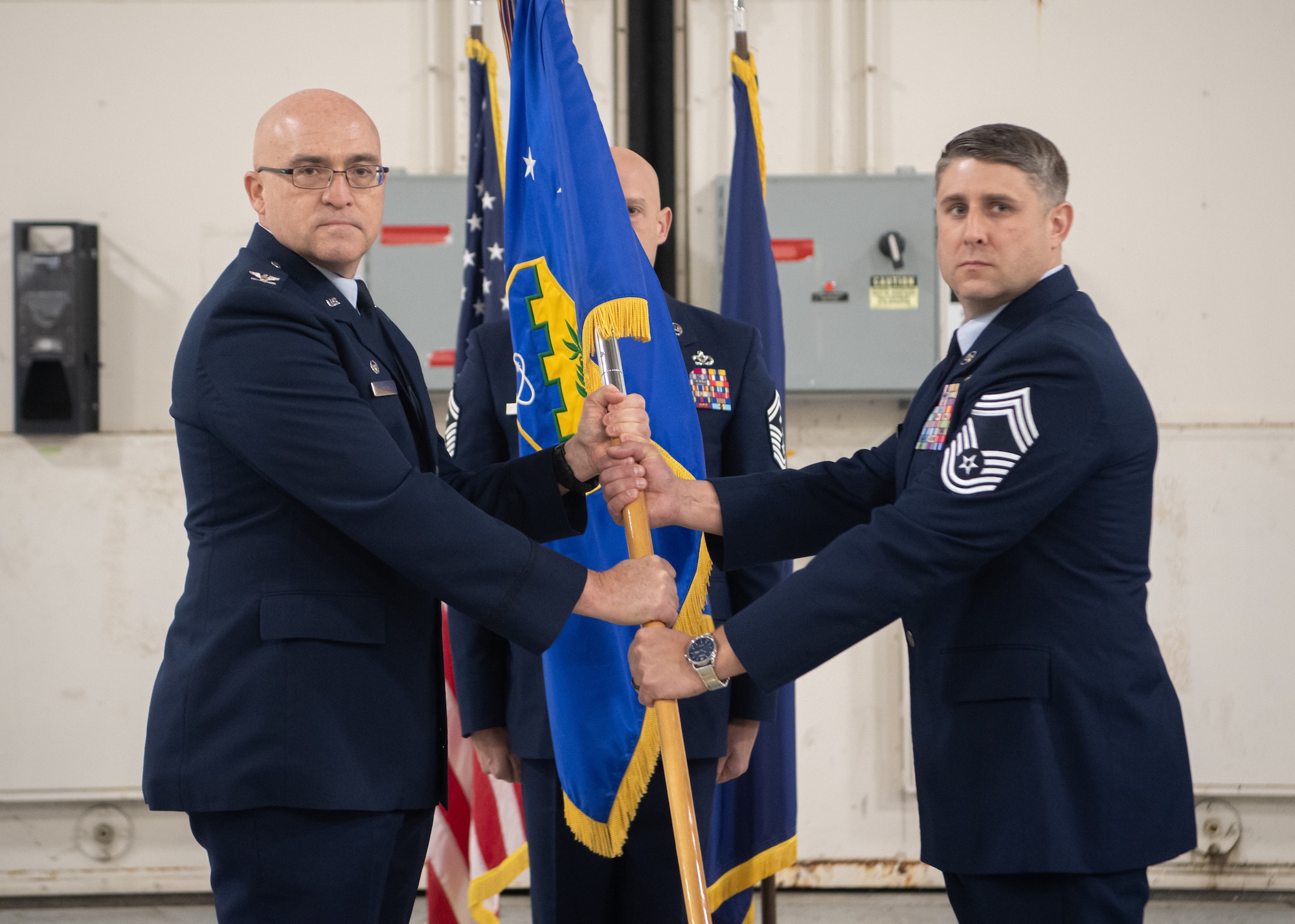 Chief Master Sgt. Patrick Judy (right), 193rd Special Operations Wing command chief, accepts the wing guidon from Col. Robert Noren, 193rd SOW commander, during an assumption of responsibility ceremony at the 193rd SOW in Middletown, Pennsylvania, Dec. 6, 2025.