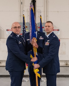 MIDDLETOWN, Pa – Lt Col. Lee Dewald (right) receives the guidon from Col. Robert Noren, 193rd Special Operations Wing commander, during a change of command ceremony for the 193rd Special Operations Mission Support Group in Middletown, Pa., Dec. 5, 2025.