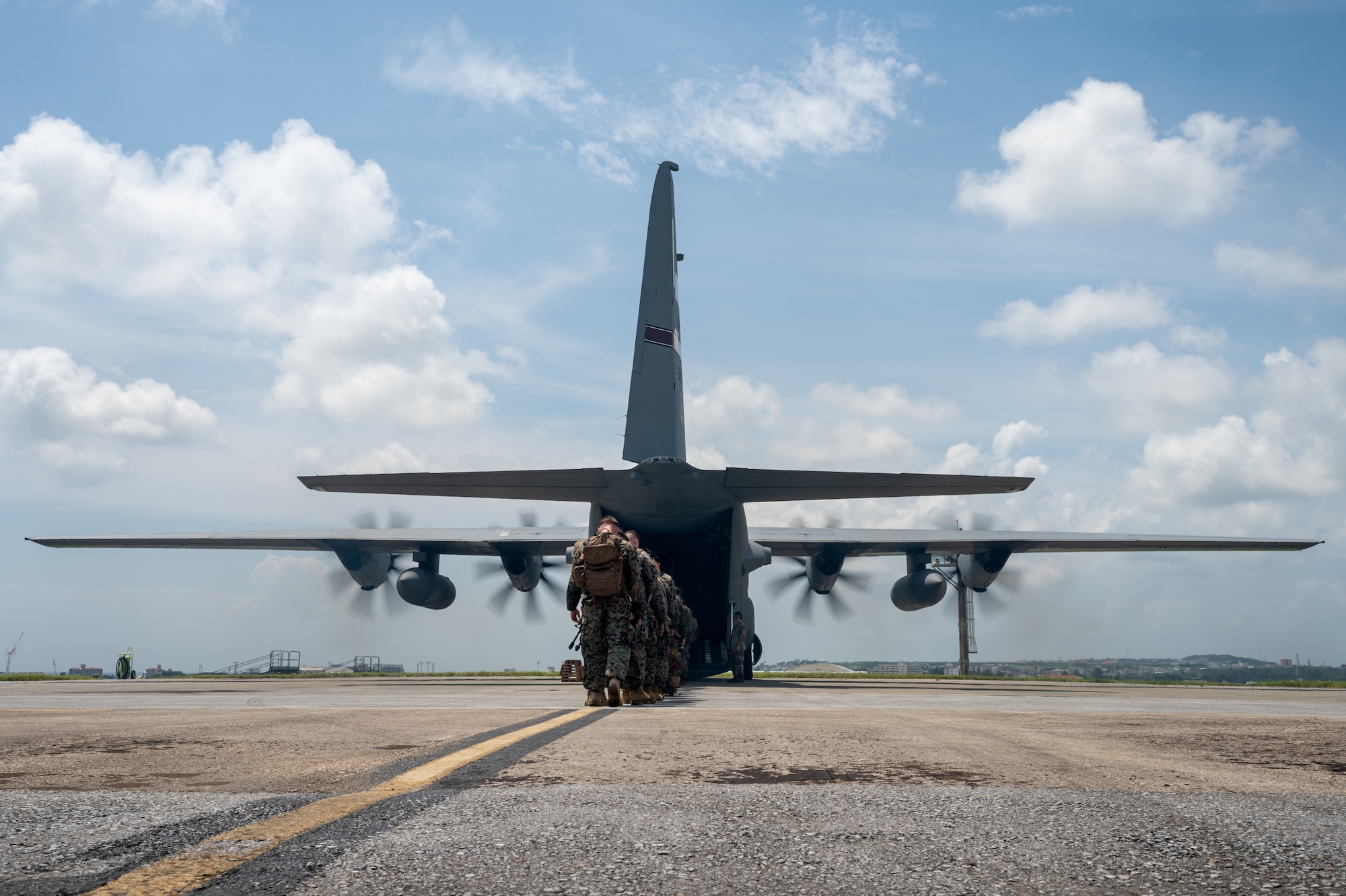 uniformed members line up to board an aircraft view from behind the line