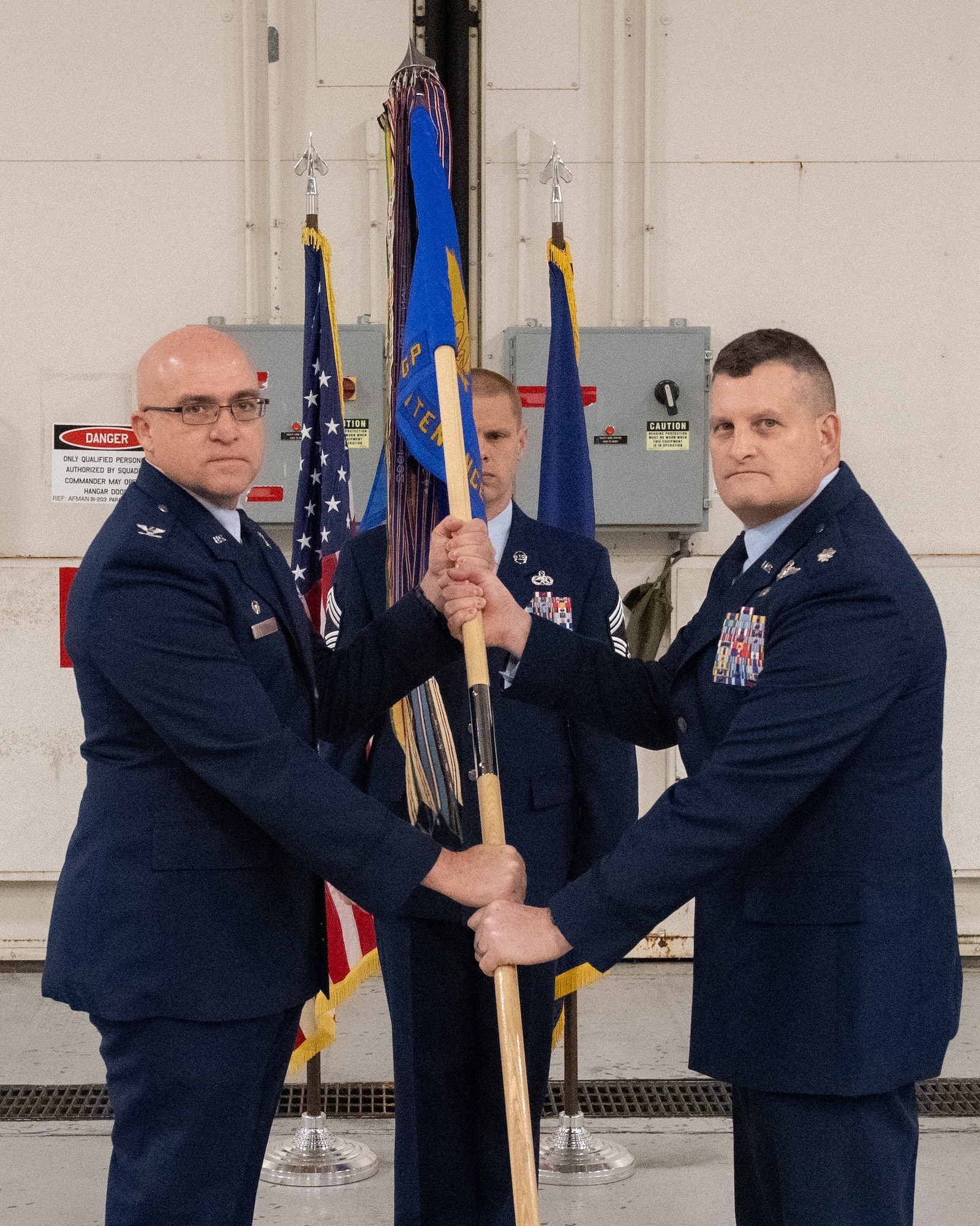 Lt. Col. Michael Hackman (right) receives the guidon from Col. Robert Noren, 193rd Special Operations Wing commander, during a change of command ceremony for the 193rd Special Operations Maintenance Group in Middletown, Pa., Dec. 5, 2025.