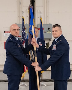 Lt. Col. Michael Hackman (right) receives the guidon from Col. Robert Noren, 193rd Special Operations Wing commander, during a change of command ceremony for the 193rd Special Operations Maintenance Group in Middletown, Pa., Dec. 5, 2025.