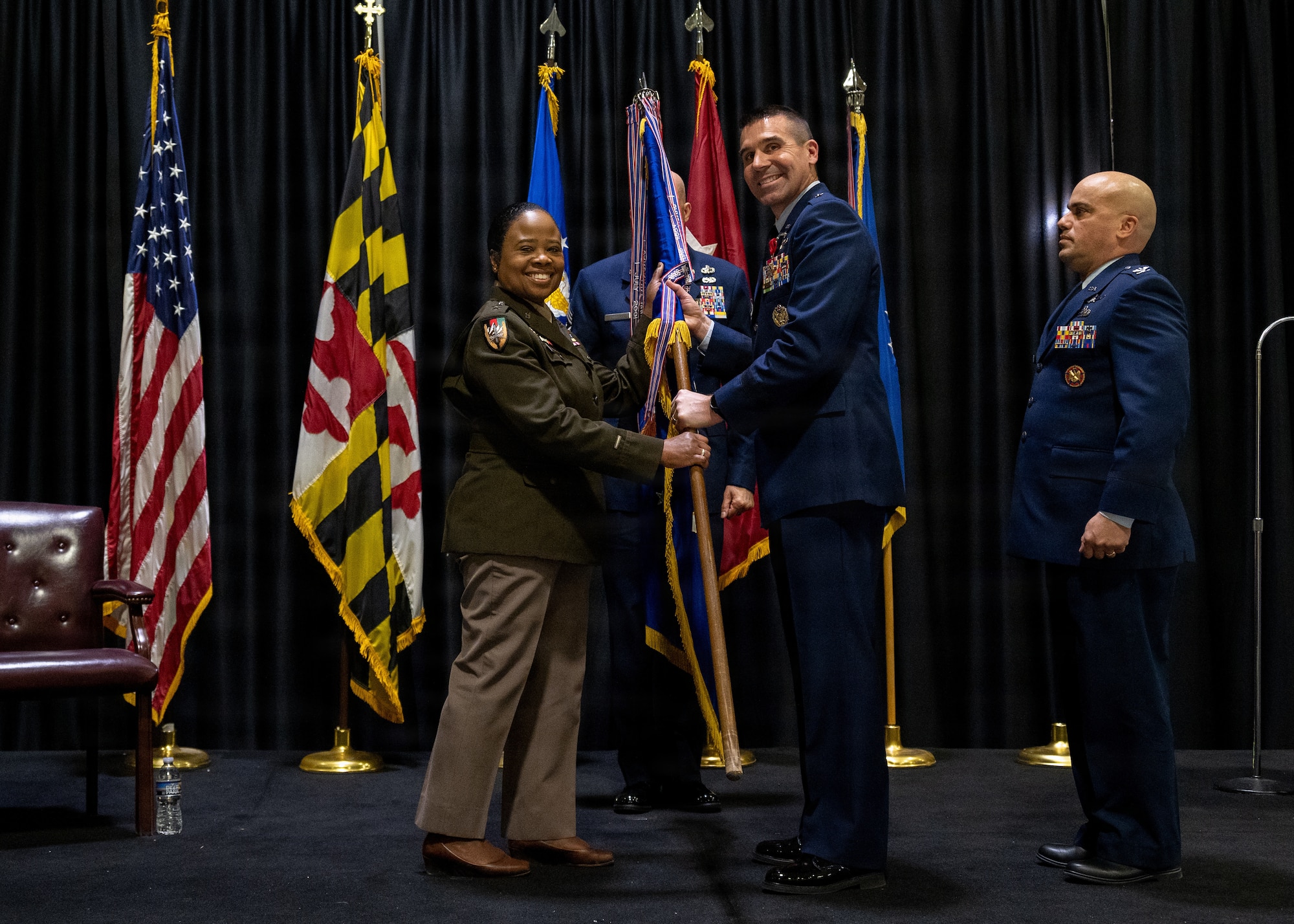 Maryland Air National Guard Brig. Gen. Richard Hunt, previous 175th Wing commander, passes the guidon to Maryland Army National Guard Maj. Gen. Janeen L. Birckhead, adjutant general of Maryland, during the 175th Wing change of command ceremony in which Hunt relinquished command to Maryland Air National Guard Col. Joed I. Carbonell, December 7, 2025, at Warfield Air National Guard Base at Martin State Airport, Middle River, Maryland. Hunt has a long history in the Maryland Air National Guard, beginning his career as an enlisted member and working all the way up to wing commander and now interim assistant adjutant general. (U.S. Air National Guard photo by Airman 1st Class Sarah Hoover)