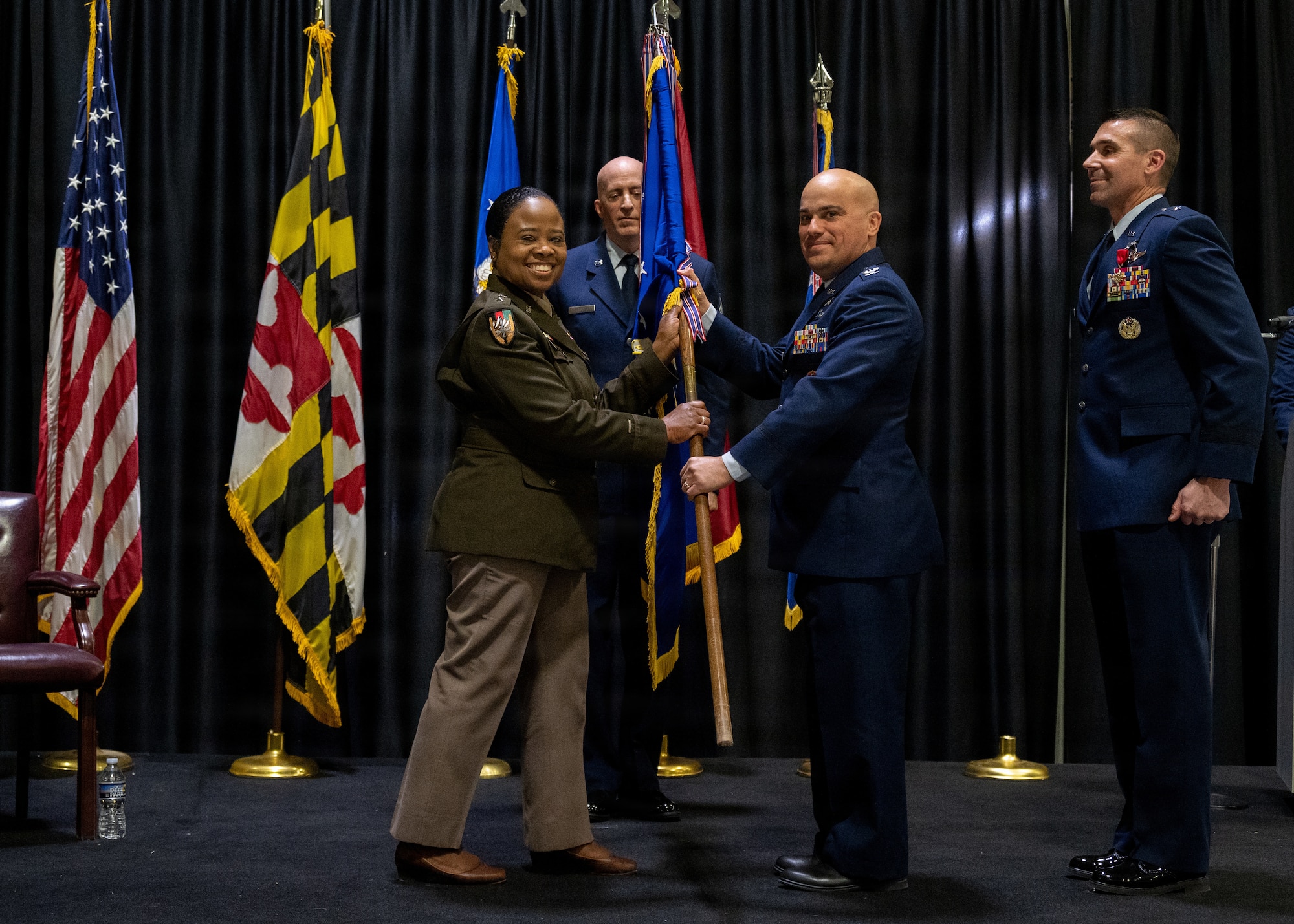 Maryland Army National Guard Maj. Gen. Janeen L. Birckhead, adjutant general of Maryland, passes the guidon to Maryland Air National Guard Col. Joed I. Carbonell, during the 175th Wing change of command ceremony in which Maryland Air National Guard Brig. Gen. Richard Hunt relinquished command to Carbonell, December 7, 2025, at Warfield Air National Guard Base at Martin State Airport, Middle River, Maryland. Carbonell comes to the 175th Wing from the 179th Cyberspace Operations Group at Mansfield Air National Guard Base, Ohio where he was the commander. (U.S. Air National Guard photo by Airman 1st Class Sarah Hoover)
