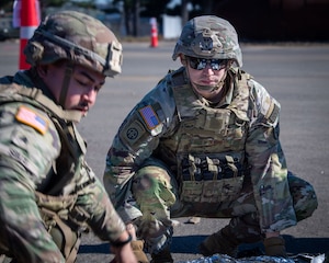 U.S. Army medical personnel move simulated casualties to safety.