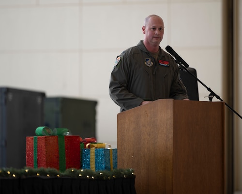 A military member speaks behind a podium.