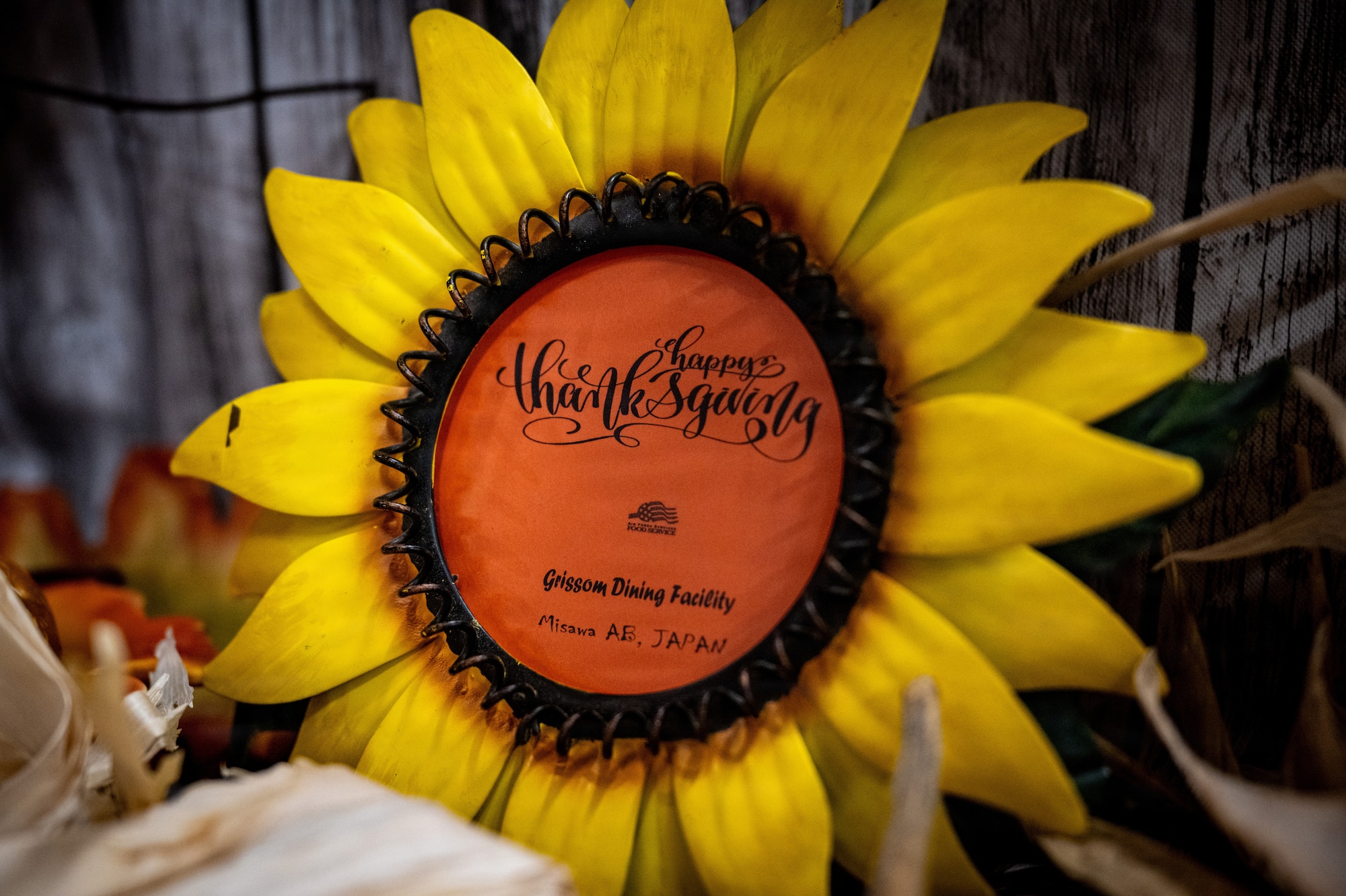 A “Happy Thanksgiving” sign is displayed during the Thanksgiving Holiday Meal.