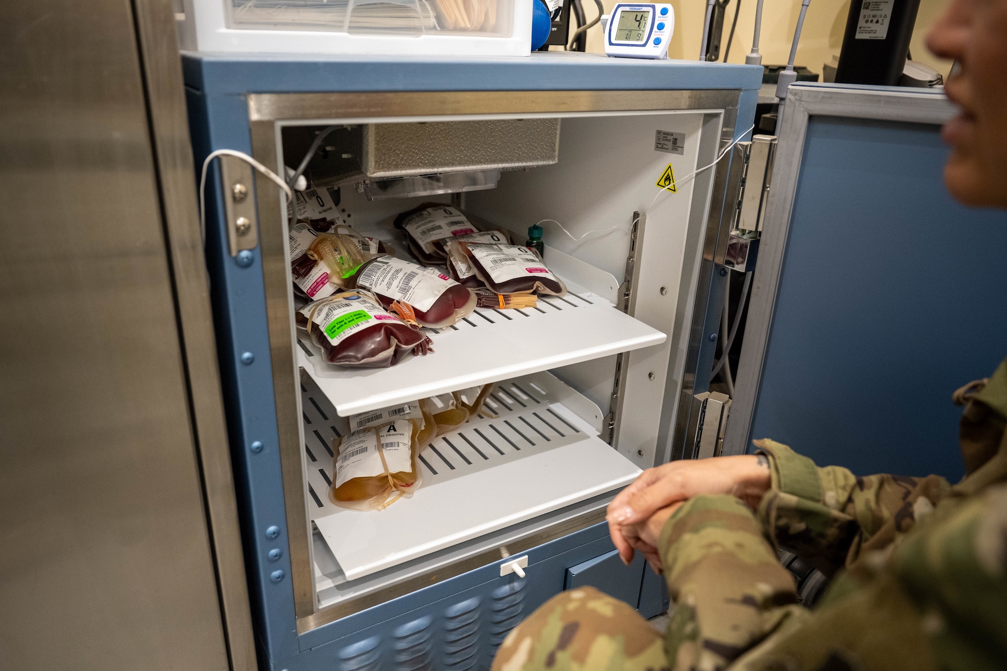 U.S. Air Force Master Sgt. Malissa Ross, 332nd Expeditionary Medical Squadron laboratory noncommissioned officer in charge, stores blood in a refrigerator at the 332nd Expeditionary Medical Squadron in the U.S. Central Command area of responsibility, Nov. 13, 2025