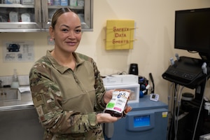 U.S. Air Force Master Sgt. Malissa Ross, 332nd Expeditionary Medical Squadron laboratory noncommissioned officer in charge, holds a container of blood in the U.S. Central Command area of responsibility, Nov. 13, 2025.