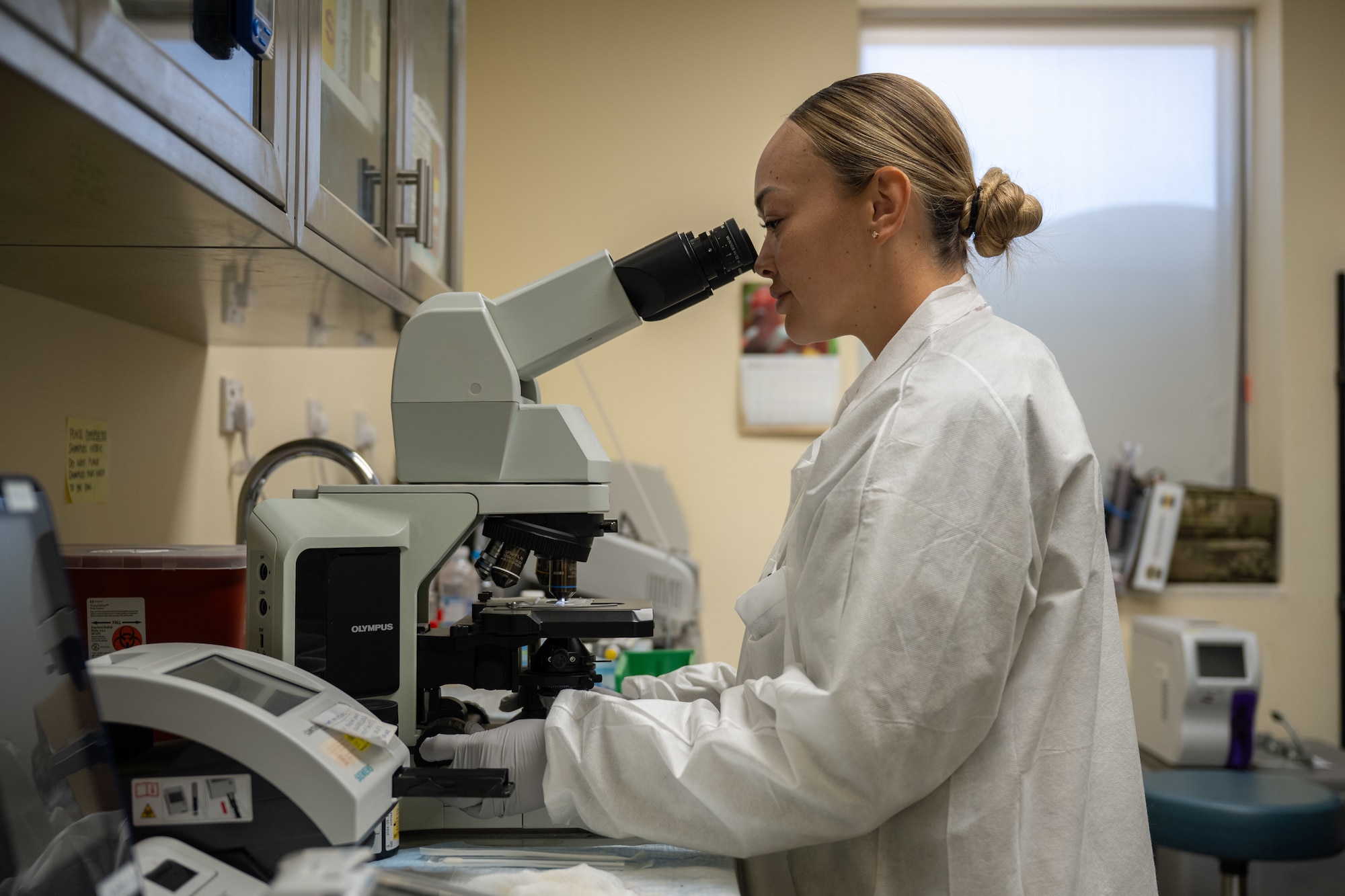 U.S. Air Force Master Sgt. Malissa Ross, 332nd Expeditionary Medical Squadron laboratory noncommissioned officer in charge, looks through a microscope in the U.S. Central Command area of responsibility, Nov. 13, 2025.