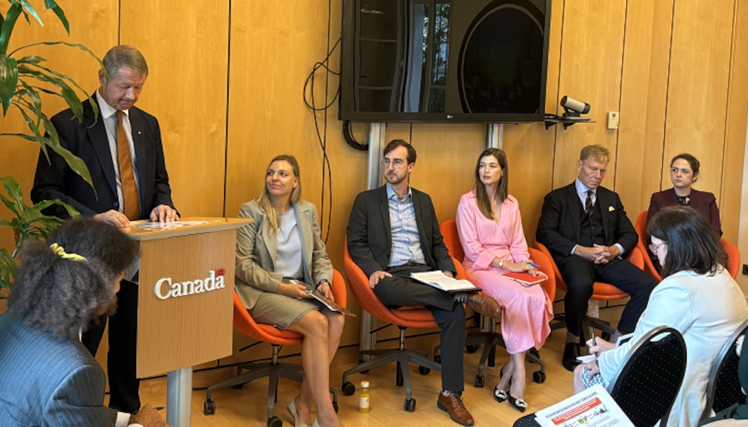 INSS Senior Policy Fellow Sarah Gamberini (left) sits ads she listens to a speaker during a panel side session during the Executive Committee meeting in the Hague of the Organization for the Prohibition of Chemical Weapons in an effort to bolster the norm against chemical weapons and provide countries layered solutions for countering manipulated narratives about CWC compliance.