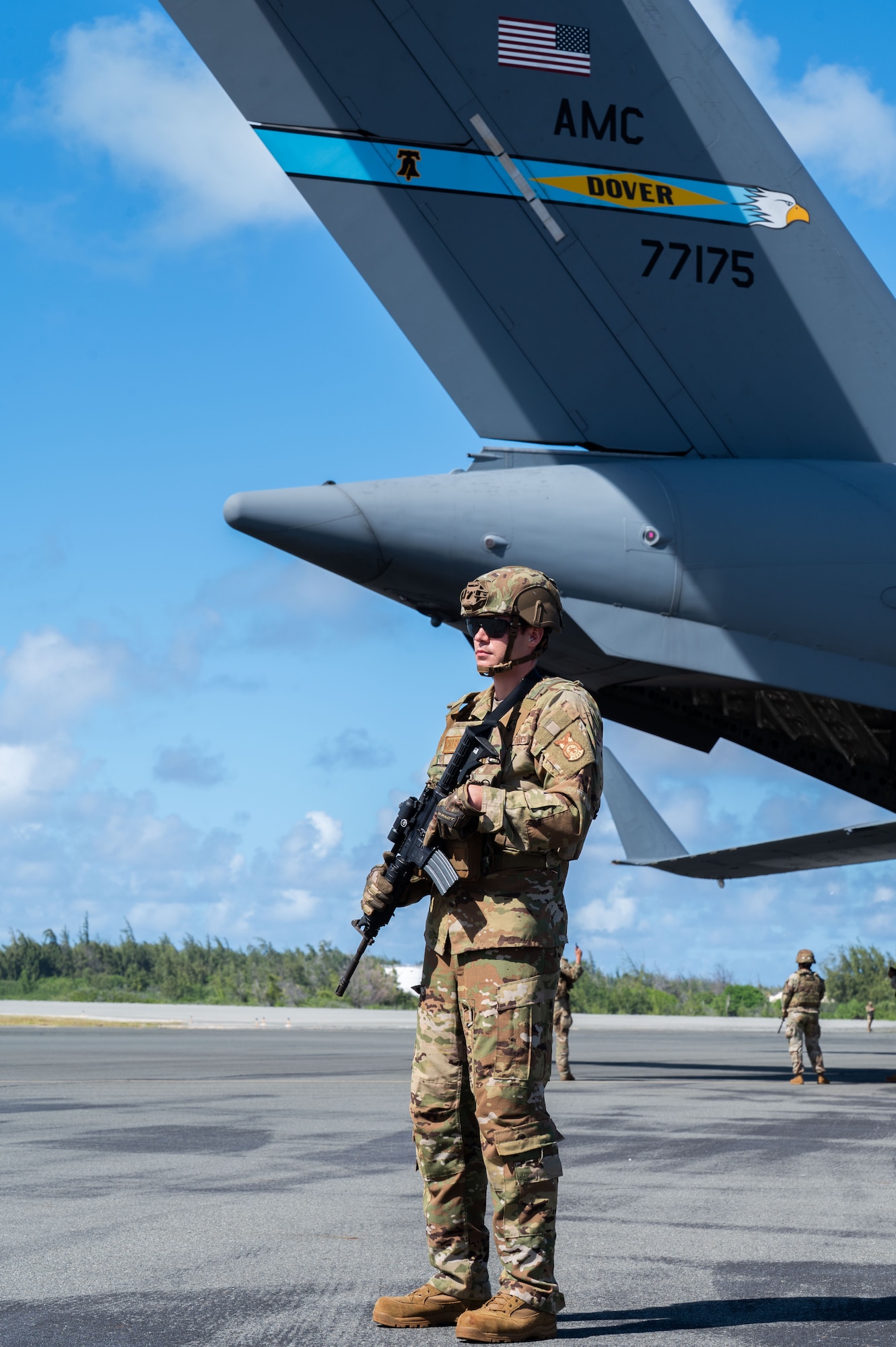 U.S. Air Force Staff Sgt. Jason Wilson, 21st Combat Air Base Squadron firefighter, provides security of a U.S. Air Force C-17 Globemaster III from Dover Air Force Base, Delaware, during Joint Pacific Multinational Readiness Center 26-01 at Wake Island, Nov. 13, 2025. JPMRC 26-01 highlights the U.S. commitment to partnership and a free and open Indo-Pacific, bringing together U.S. Joint Force and multinational Allies and partners to strengthen defense relationships, foster interoperability, and generate readiness. (U.S. Air Force photo by Senior Airman Alondra Cristobal Hernandez)