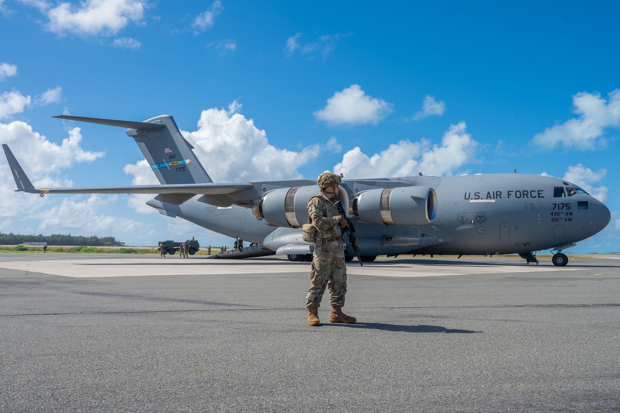 U.S. Air Force Staff Sgt. Carlos Tornero, 21st Combat Air Base Squadron stockpile management crew chief, secures a U.S. Air Force C-17 Globemaster III from Dover Air Force Base, Delaware, during a High Mobility Artillery Rocket System (HIMARS) Rapid Infiltration (HIRAIN) as part of the Joint Pacific Multinational Readiness Center 26-01 at Wake Island, Nov. 13, 2025. JPMRC 26-01 supported the 21st ATF’s objective to execute rapid force flow in contested environments. (U.S. Air Force photo by Senior Airman Alondra Cristobal Hernandez)