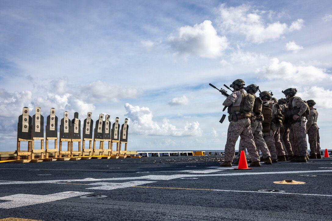 U.S. Marines with India Company, Battalion Landing Team 3/6, 22nd Marine Expeditionary Unit (Special Operations Capable), conduct a speed reload drill during a deck shoot aboard the San Antonio-class amphibious transport dock USS Fort Lauderdale (LPD 28) while underway in the Caribbean Sea, Nov. 25, 2025. U.S. military forces are deployed to the Caribbean in support of the U.S. Southern Command mission, Department of War-directed operations, and the president's priorities to disrupt illicit drug trafficking and protect the homeland. (U.S. Marine Corps photo)