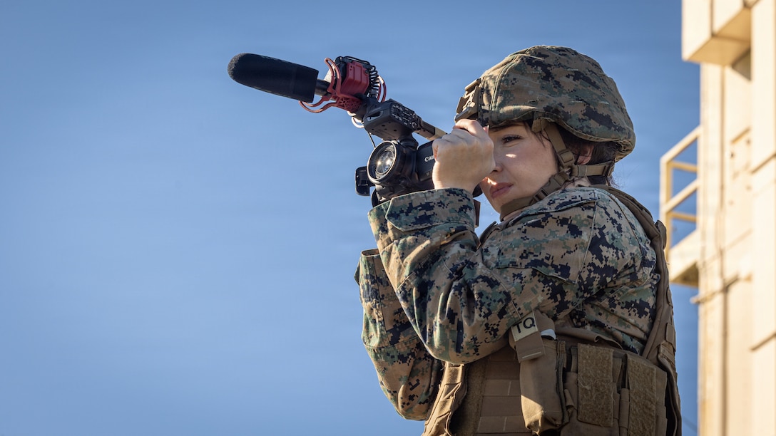 U.S. Marine Corps Lance Cpl. Isabelle Hutmacher, a native of Ohio and a combat graphics specialist with Headquarters Battalion, 2nd Marine Division, takes video of a fire integration support control exercise on Marine Corps Base Camp Lejeune, North Carolina, Oct. 16, 2025. The exercise reinforces critical skills for fire integration support teams and increases their effectiveness and lethality. (U.S. Marine Corps photo by Lance Cpl. Brian Bolin Jr.)