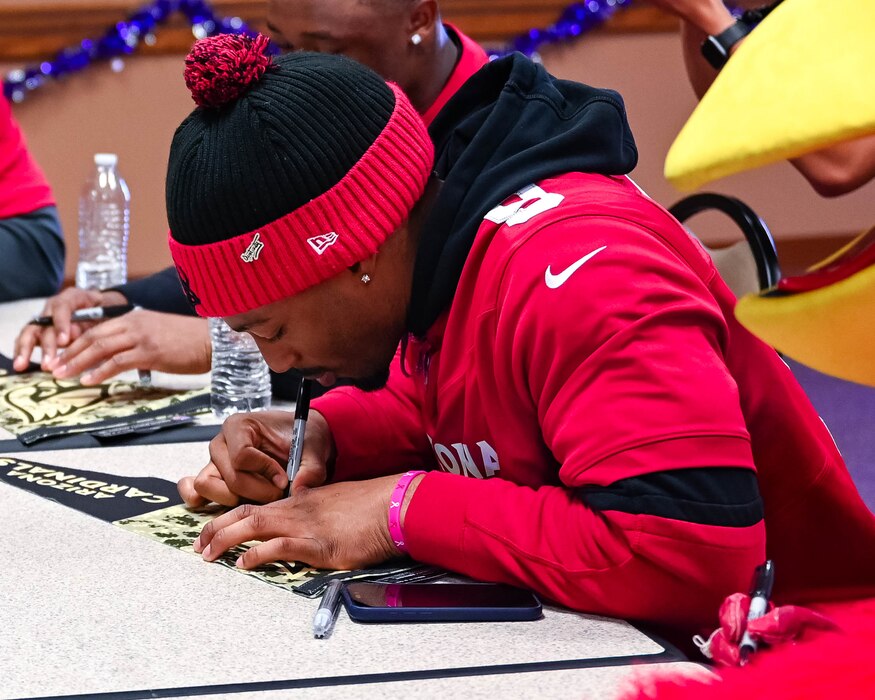Arizona Cardinals Linebacker Bj Ojulari, signs Cardinals equipment for U.S. Air Force members, Dec. 2, 2025, at Goldwater Air National Guard Base, Arizona.