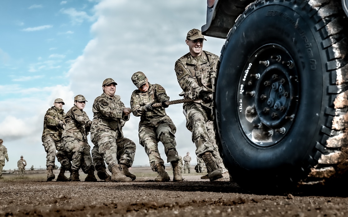 U.S. Air Force Airmen assigned to the 56th Civil Engineer Squadron, work together to pull a Humvee in a timed event during the Prime Base Engineer Emergency Force readiness challenge