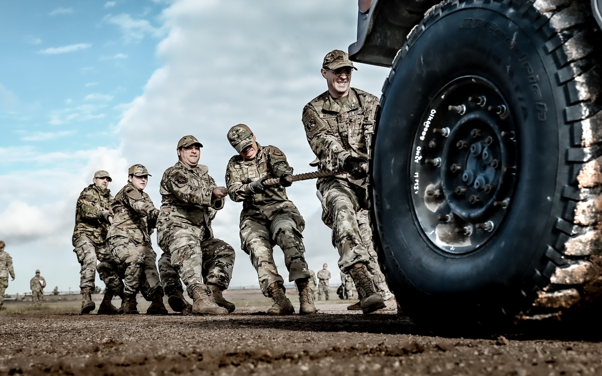 U.S. Air Force Airmen assigned to the 56th Civil Engineer Squadron, work together to pull a Humvee in a timed event during the Prime Base Engineer Emergency Force readiness challenge