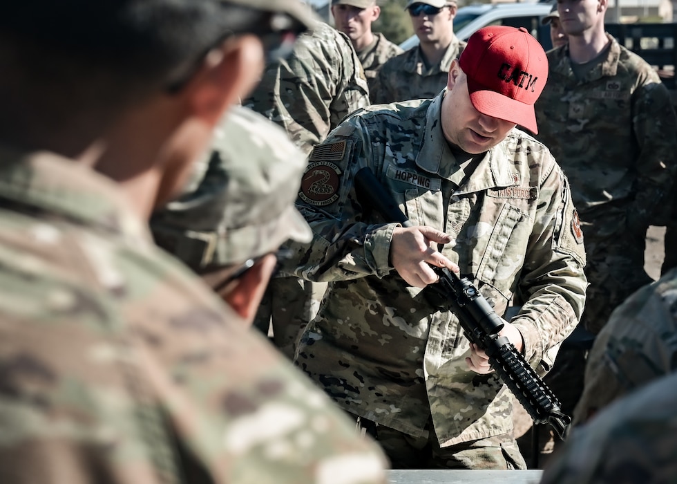 U.S. Air Force Staff Sgt. Ronald Hopping, 56th Security Forces Squadron combat arms instructor, briefs participants on the M-4 Carbine before they face a timed disassembly and assembly competition at the Prime Base Engineer Emergency Force readiness challenge
