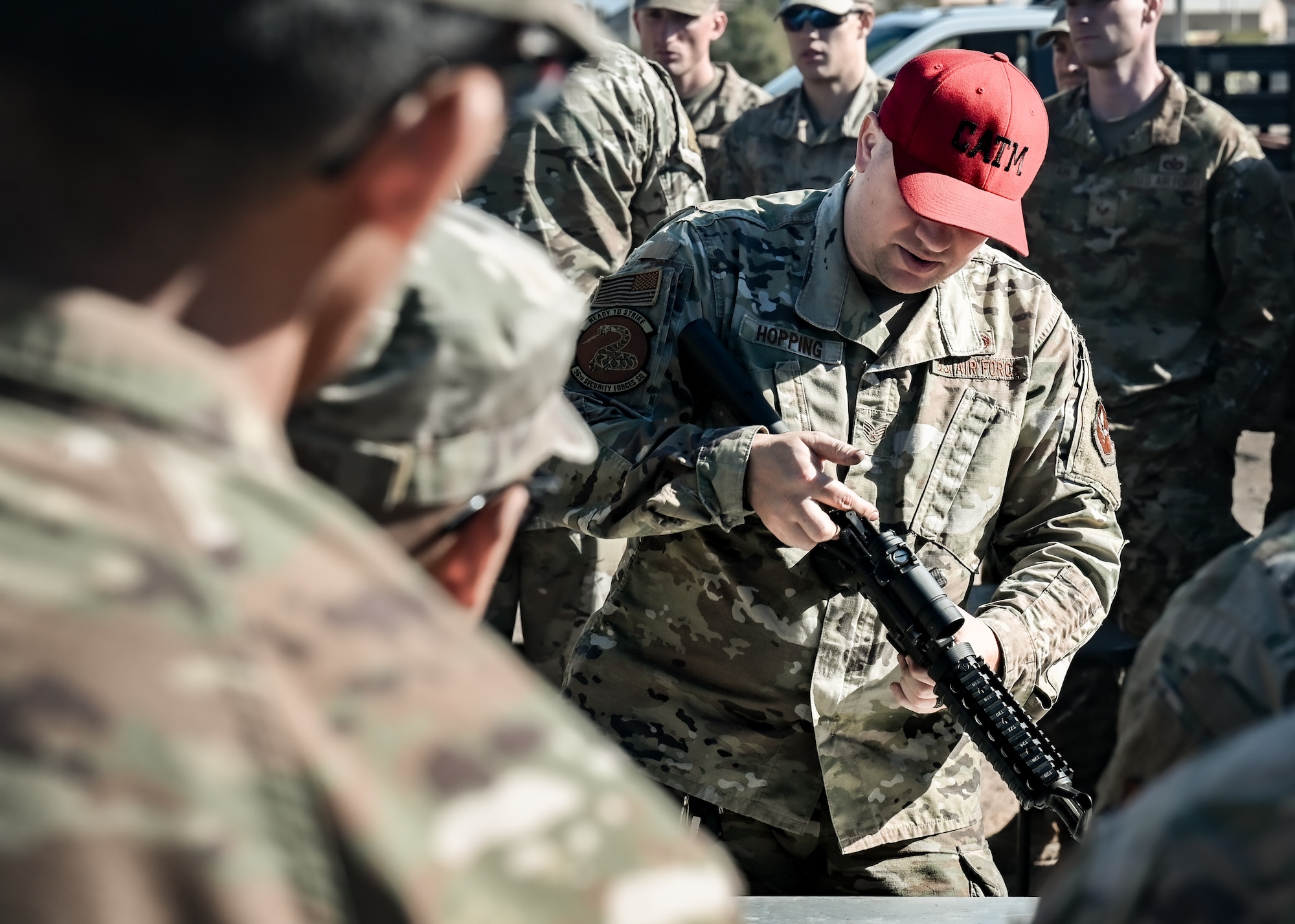 U.S. Air Force Staff Sgt. Ronald Hopping, 56th Security Forces Squadron combat arms instructor, briefs participants on the M-4 Carbine before they face a timed disassembly and assembly competition at the Prime Base Engineer Emergency Force readiness challenge