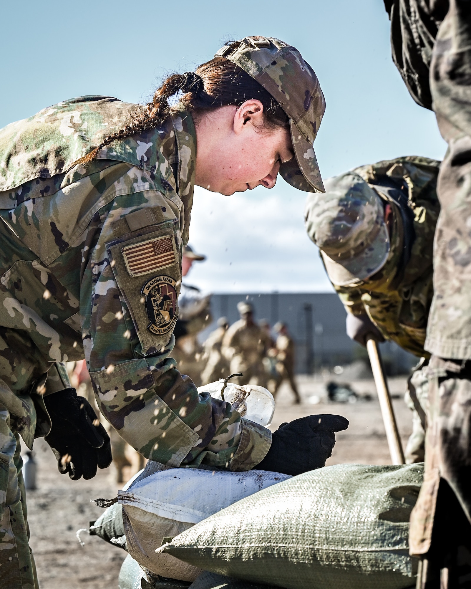 U.S. Air Force Senior Airman Maria Easterling, 56th Civil Engineer Squadron engineering specialist, assembles a defensive firing post with bags of dirt as part of the Prime Base Engineer Emergency Force readiness challenge