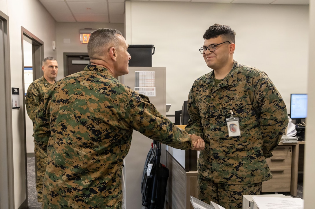 U.S. Marine Corps Brig. Gen. Ralph J. Rizzo, Jr., commanding general, recognizes Lance Cpl. Jashua Martinezcarjaval, a legal services specialist, Marine Corps Installations East-Marine Corps Base (MCB) Camp Lejeune, while touring the newly constructed Regional Law Center East on MCB Camp Lejeune, North Carolina, Dec. 2, 2025. The new regional law center marks a major modernization effort that improves operational efficiency by housing legal support functions in one building and restores legal capabilities displaced by Hurricane Florence across MCB Camp Lejeune. (U.S. Marine Corps photo by Lance Cpl. Erica S. Padgett)
