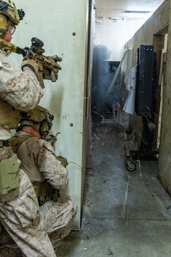 Reconnaissance Marines with the 24th Marine Expeditionary Unit (MEU), take cover as they breach a door with explosives as part of Close Quarters Tactics training on Stone Bay, Camp Lejeune, North Carolina, on December 03, 2025. The 24th MEU is a Marine Air-Ground Task Force ready to answer the nation's call in any clime and place. (U.S. Marine Corps photo by Cpl. Daniel R. Garcia)
