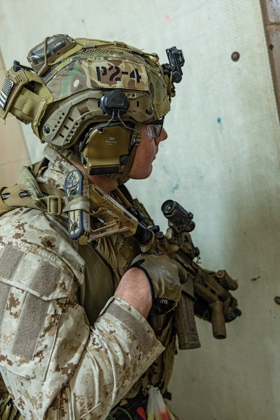 A Reconnaissance Marine with the 24th Marine Expeditionary Unit (MEU), takes cover as explosives are being placed on a door as part of Close Quarters Tactics training on Stone Bay, Camp Lejeune, North Carolina, on December 03, 2025. The 24th MEU is a Marine Air-Ground Task Force ready to answer the nation's call in any clime and place. (U.S. Marine Corps photo by Cpl. Daniel R. Garcia)