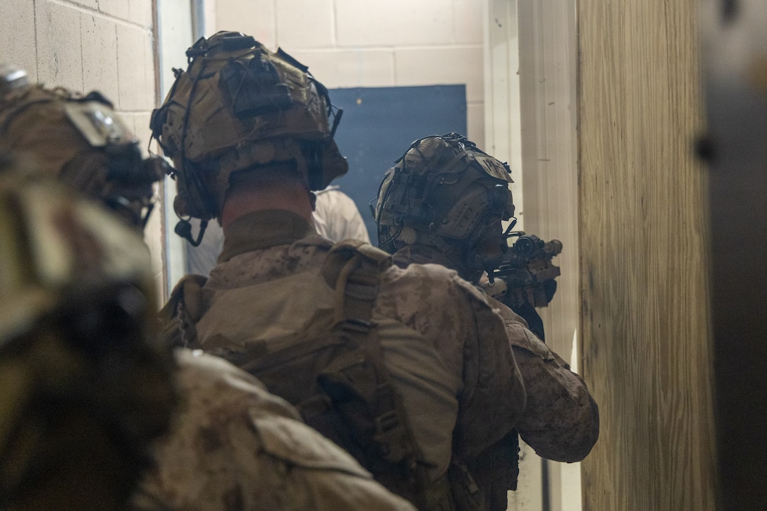 Reconnaissance Marines with the 24th Marine Expeditionary Unit (MEU), prepare to breach a room as part of Close Quarters Tactics training on Stone Bay, Camp Lejeune, North Carolina, on December 03, 2025. The 24th MEU is a Marine Air-Ground Task Force ready to answer the nation's call in any clime and place. (U.S. Marine Corps photo by Cpl. Daniel R. Garcia)