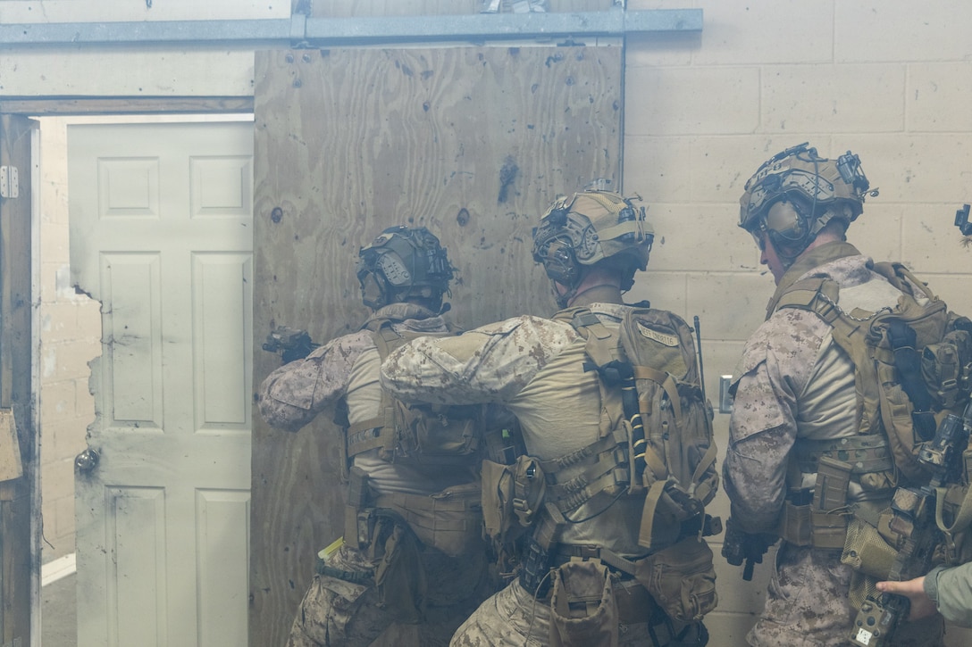 Reconnaissance Marines with the 24th Marine Expeditionary Unit (MEU), prepare to breach a room as part of Close Quarters Tactics training on Stone Bay, Camp Lejeune, North Carolina, on December 03, 2025. The 24th MEU is a Marine Air-Ground Task Force ready to answer the nation's call in any clime and place.  (U.S. Marine Corps photo by Cpl. Daniel R. Garcia)