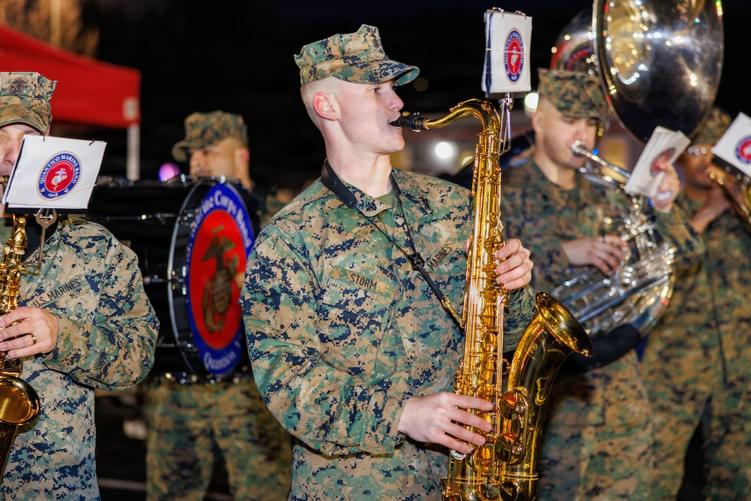 Santa takes a photo with a family during his visit to the holiday festival at Marine Corps Base Quantico, Dec. 4, 2025. The festival featured holiday crafts, a seasonal market with local vendors, food trucks, ice skating, snowball fights and photos with Santa. (U.S. Marine Corps photo by Lance Cpl. Federico Marquez)
