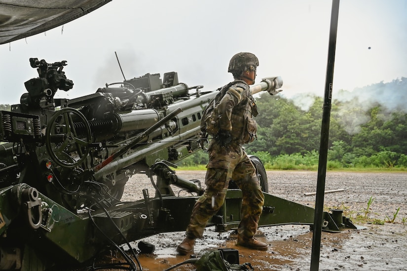 A round can be seen as a Soldier from 2-12 FA fires an M777 howitzer during Table VI qualification at Rodriguez Live Fire Complex, South Korea, Aug. 13, 2025. The live-fire event tested crews on accuracy, speed, and communication under realistic conditions.