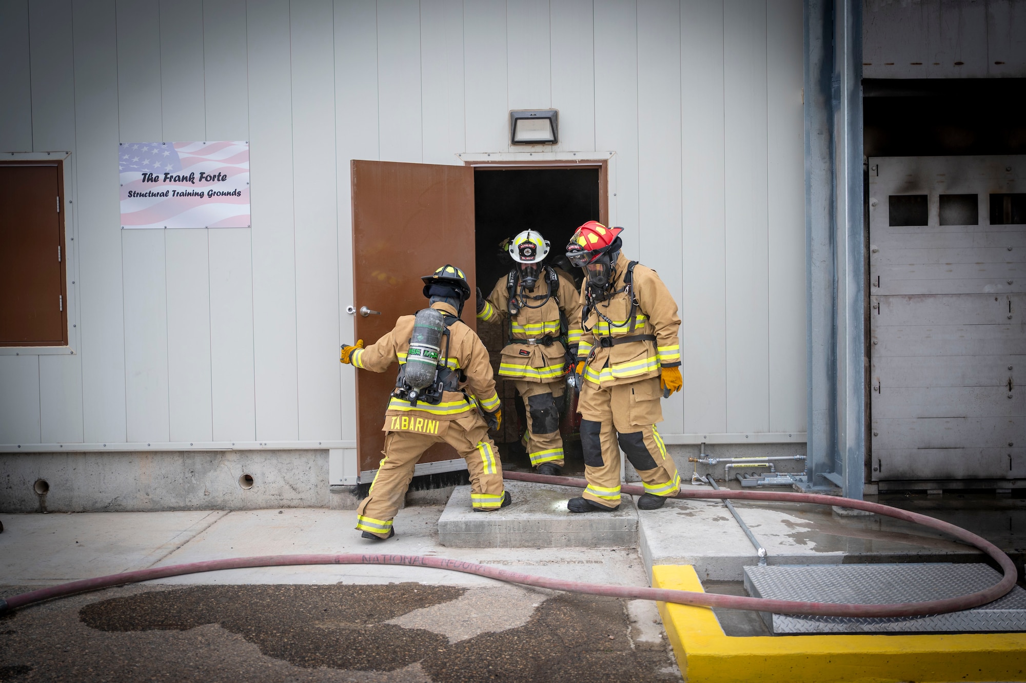 Firefighters search building during training exercise