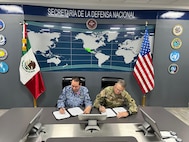 U.S. Army Maj. Gen. Matthew P. Beevers and Maj. Gen. Javier Sandoval Duenas, deputy chief of military doctrine of the National Defense Joint Headquarters Staff, or EMCDN, sign a letter of intent formalizing the agreement for Mexico to join the Department of War National Guard Bureau's State Partnership Program with the California National Guard.