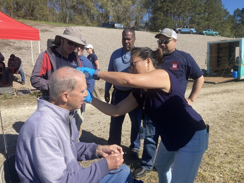 Emily Russell, an occupational health registered nurse (RN) with the U.S. Army Corps of Engineers (USACE) Charleston District attends to a veteran needing medical attention during the 11th annual Wounded Warrior Veterans Fishing Day held for military veterans to promote relaxation and recreation.